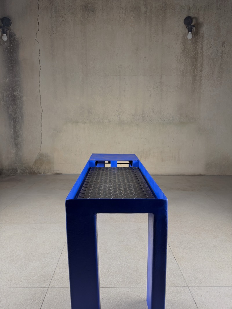 Archival end-on view down the length of the ultramarine bench.